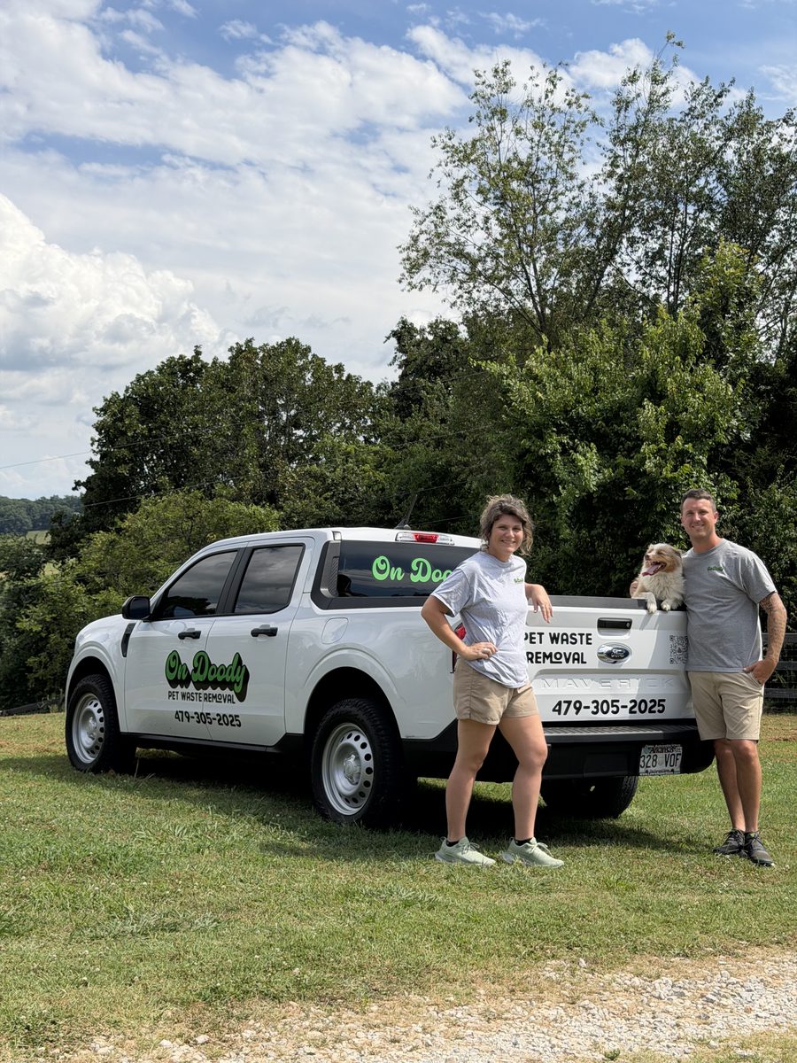 The On Doody team and pup by the company truck